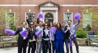 Alumni waving purple pom-poms in Vanderbilt Hall courtyard