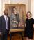 Troy McKenzie and Courtney O'Malley standing next to a portrait of Florence Davis