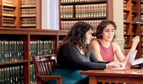 Two students at a table in library
