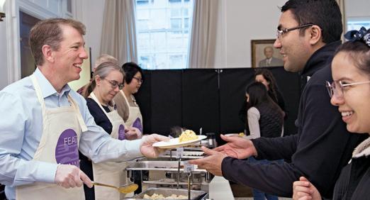 Trevor Morrison serving breakfast to students