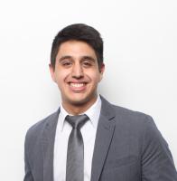 Man in grey suit and grey tie